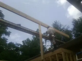 Carpenter setting a ridge beam over a new addition frame — Ice Dam Removal by Roofing Brothers in Dover Plains