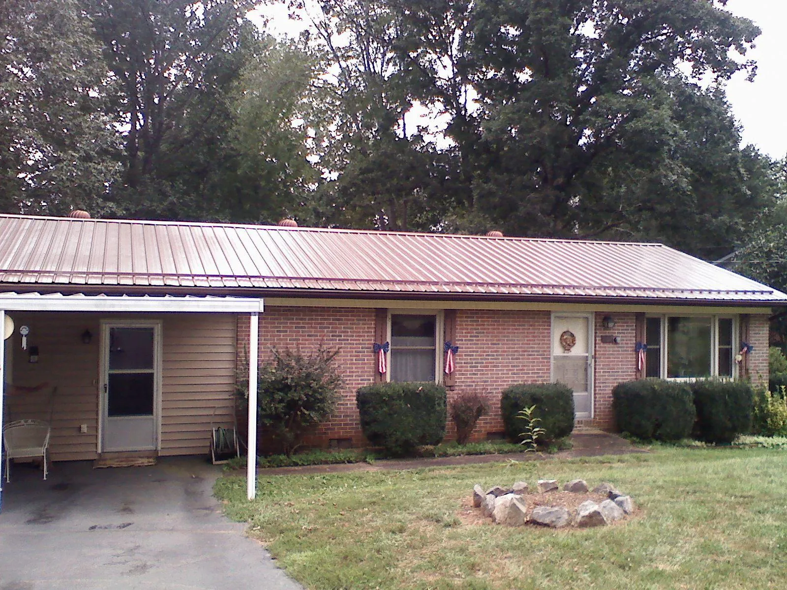 Bronze metal roof and carport on a brick ranch home — Roof Repair work by our crew in Dover Plains