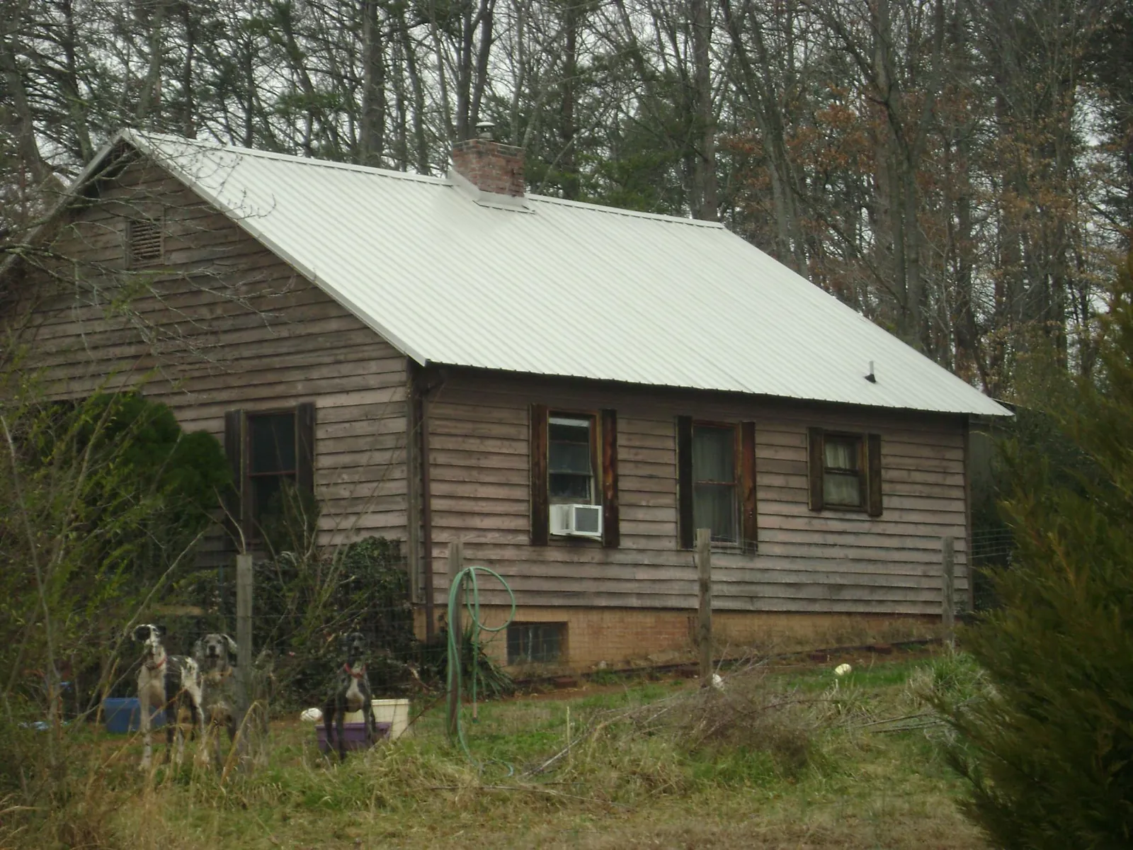 White metal roof on an old wood sided farmhouse, from a Metal Roof Installation job in Dover Plains